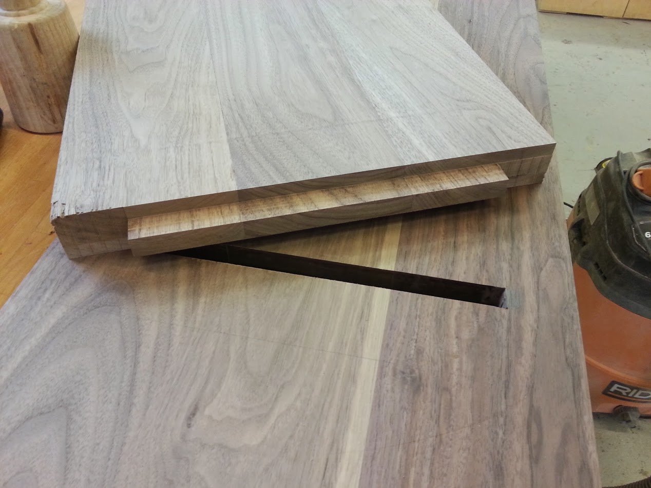 Walnut bench showing long mortise and tenon where where the legs attach